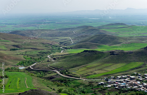 view of the village a beautiful road around the mountains in spring  photo