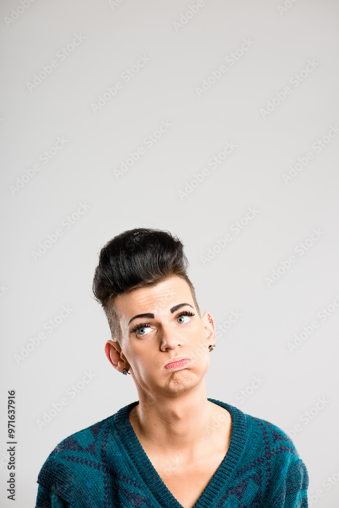 Transgender person, tired and thinking in studio for discrimination, anxiety and bored. Man, cosmetics and frustrated on white background space with identity crisis with makeup for aesthetic or pride Transgender person, tired and thinking in studio for discrimination, anxiety and bored. Man, cosmetics and frustrated on white background space with identity crisis with makeup for aesthetic or pride