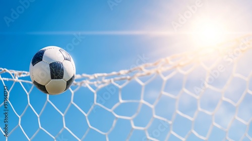 Ball and net, scoring moment under a clear sky.