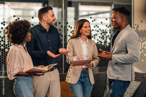 Happy diverse causal executives working on business strategy at lobby.