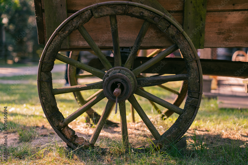 Old wooden cart with large wheels. Western style wagon wheel. Old wooden cart with large wheels. Western style wagon wheel.
