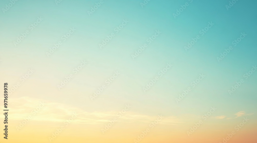 Obraz premium A clear sky displays a soft gradient of colors, where shades of sky blue gently merge with warm oranges on the horizon. Beautiful sky with a sense of serenity.