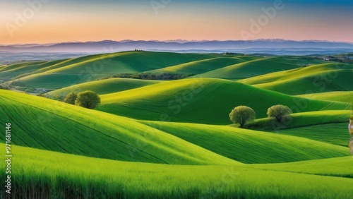 Lush green rolling hills under a vibrant sky at sunset.