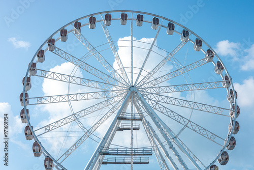 A ferris wheel stands tall against blue sky