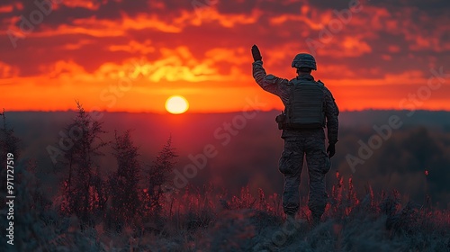 Obraz na płótnie A soldier salutes the rising sun during a beautiful sunrise, while standing on a hill overlooking a forest. w salonie