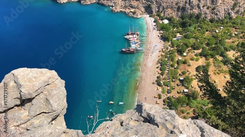 The pristine coastline and crystal clear waters of the Butterfly Valley in Oludeniz, Fethiye, Mugle, Turkey. The beach of the Valley of the Butterfly. A beach with fine white and soft sand. 4K photo