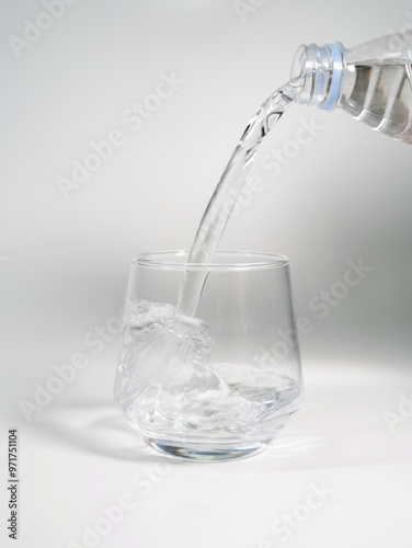 Pour Water Into Empty Glass Isolated On White Background