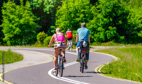 Wallpaper Mural Cyclists ride on the bike path in the city Park
 Torontodigital.ca
