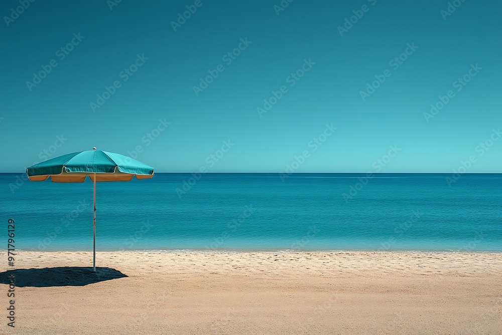 A solitary beach umbrella on a wide sandy beach with ocean and sky A solitary beach umbrella on a wide sandy beach with ocean and sky