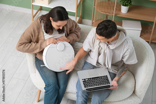 Young couple using laptop f...