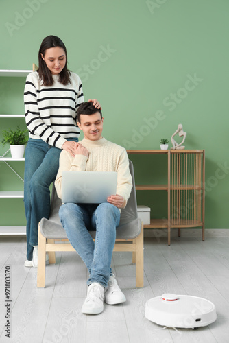 Young couple using laptop f...