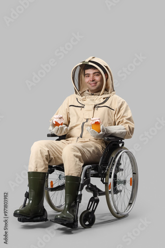 Male beekeeper in wheelchai...