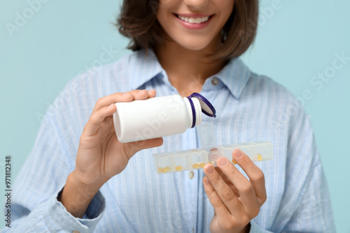 Pretty young woman putting ...