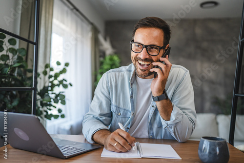 Adult man smile and enjoy while talk on mobile phone at home