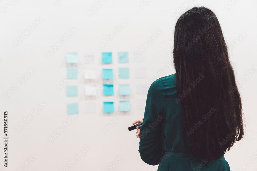 Brunette woman from the back, looking at the wall thinking Brunette woman from the back, looking at the wall thinking