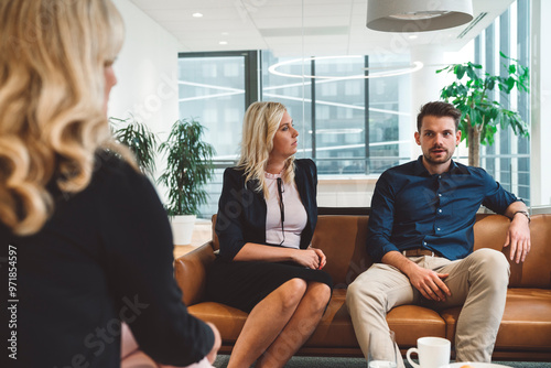 Close up, couple of colleagues discussing in the office lounge