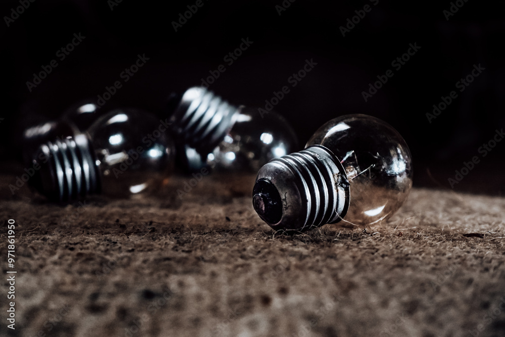 a group of light bulbs are on the table, the light bulbs are lying on the table in a low light room a group of light bulbs are on the table, the light bulbs are lying on the table in a low light room
