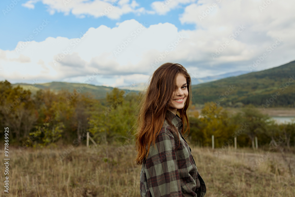 A woman in plaid shirt enjoying picturesque view of mountains in tranquil field scenery for travel inspiration and relaxation concept A woman in plaid shirt enjoying picturesque view of mountains in tranquil field scenery for travel inspiration and relaxation concept