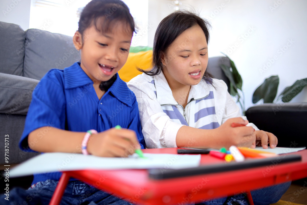 Two Asian Little Girl Drawing On Paper And Coloring Together Two Asian Little Girl Drawing On Paper And Coloring Together