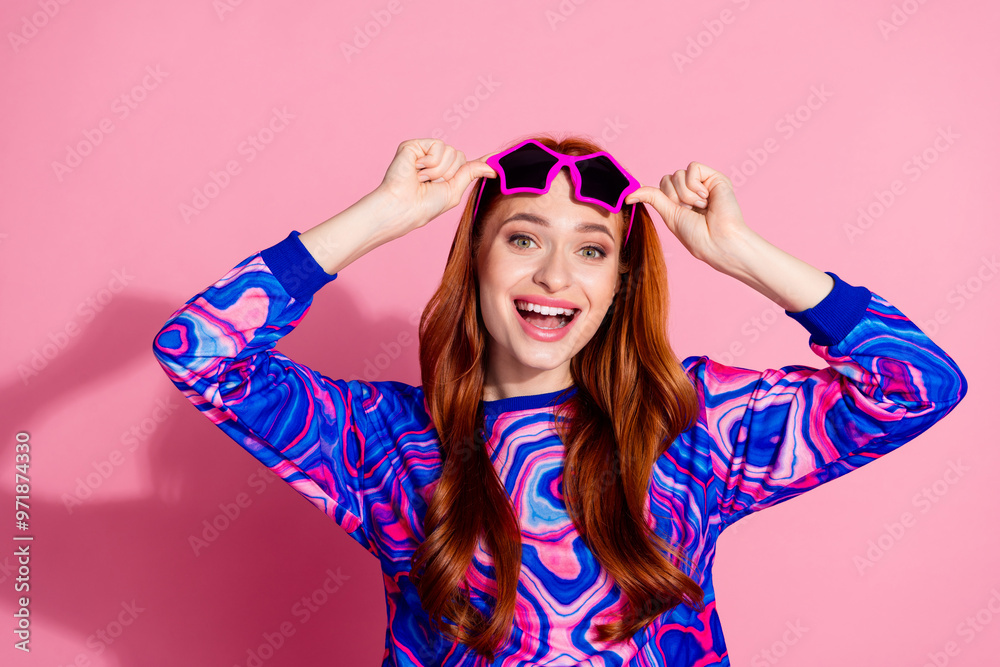 Photo of lovely young woman touch sunglass open mouth wear pullover isolated on pink color background Photo of lovely young woman touch sunglass open mouth wear pullover isolated on pink color background
