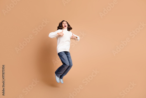 Photo of charming adorable lovely woman wear white trendy clothes thumb up isolated on beige color background