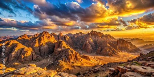 Golden sunlight casts a warm glow on the ancient biblical mountains of Monte Sinaí, Egypt, surrounded by vast desert landscapes and wispy clouds.