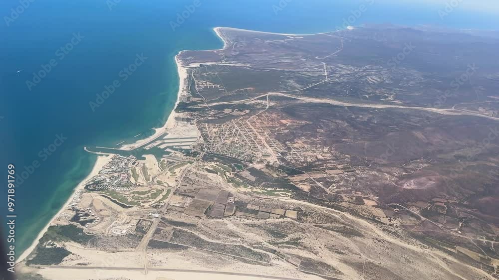 An aerial view of the coastal landscape, showcasing the blue ocean ...