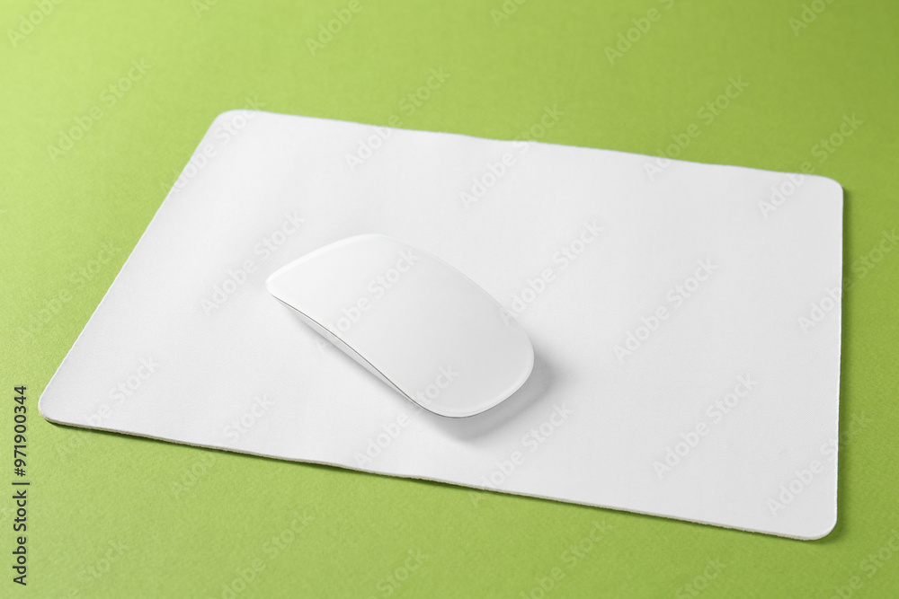 Wireless mouse and mousepad on green background Wireless mouse and mousepad on green background