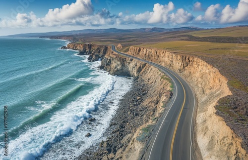 A coastal road alongside the ocean, with crashing waves and rugged cliffs, providing a dramatic view of the natural surroundings