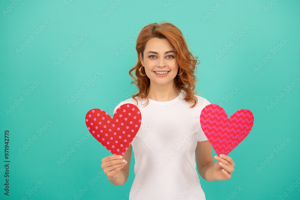 smiling young girl with red heart on blue background