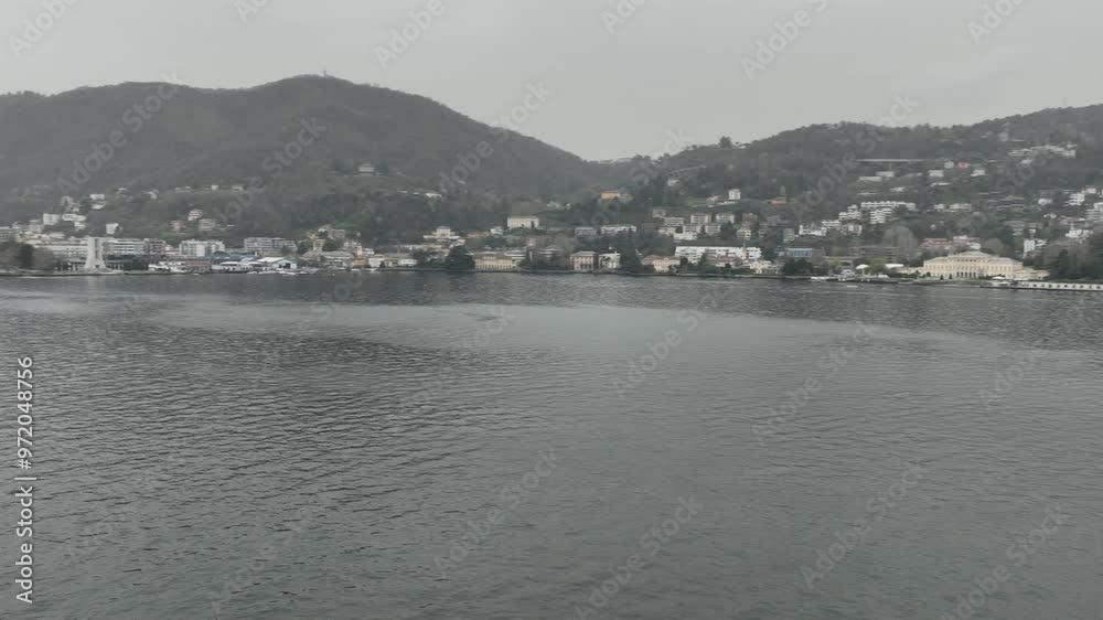 Aerial reveal rotation on the shore of Lake Como with a view of the city of Como Aerial reveal rotation on the shore of Lake Como with a view of the city of Como
