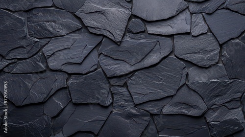 Black rough grainy stone texture, ideal for creating a dramatic backdrop for your design projects or presentations.