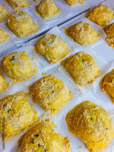 Traditional raw homemade cypriot easter cheese pastries flaounes in a table ready to be cooked.