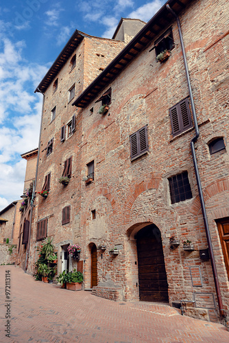 Сobblestone streets of Certaldo, surrounded by medieval architecture. Certaldo, province of Florence, Italy photo