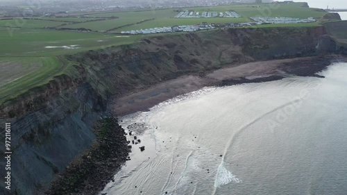 Aerial footage moving forward along the coast at saltwick bay heading towards whitby, yorkshire, uk photo