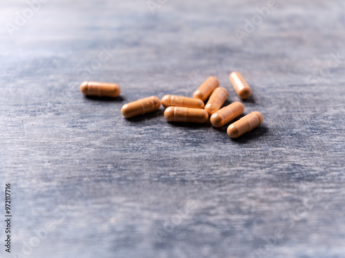 Lutein capsules. Dietary supplement on wooden background. Soft focus. Close up. Copy space.	 photo