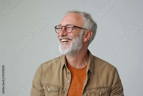 Senior man with grey hair smiling confidently.