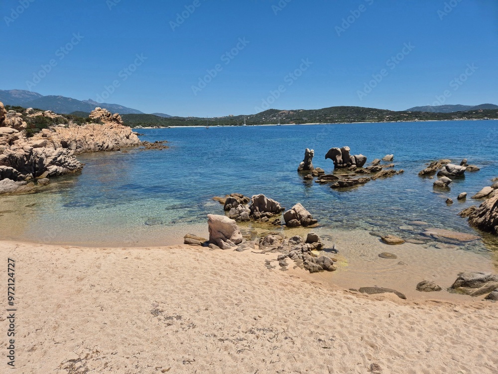 Obraz premium a deserted beach with fine sand and rocks in between at Sentier Littoral des Bruzzi, crosica, france