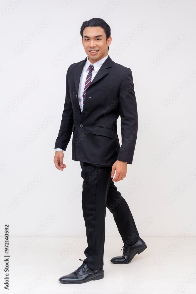 Full-body Portrait of a handsome, upbeat and confident asian businessman in a suit and tie, walking. Isolated on a white background. Full-body Portrait of a handsome, upbeat and confident asian businessman in a suit and tie, walking. Isolated on a white background.
