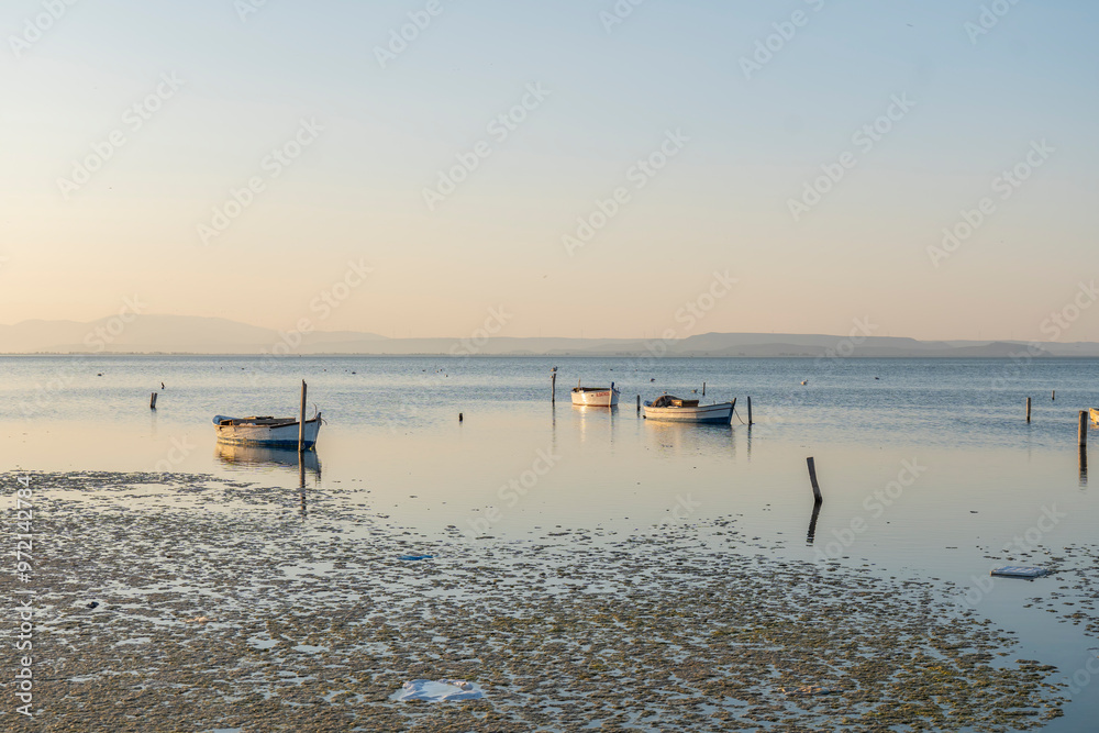Fishermans boats in the Karina region near the Soke district of Aydin province Turkey are warmed by sunlight at sunrise Fishermans boats in the Karina region near the Soke district of Aydin province Turkey are warmed by sunlight at sunrise