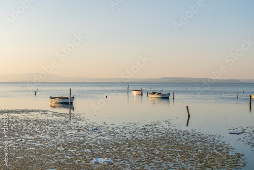 Fishermans boats in the Karina region near the Soke district of Aydin province Turkey are warmed by sunlight at sunrise photo