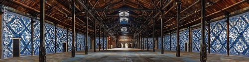 Portuguese warehouse featuring decorative blue azulejo tiles and historical iron beams.