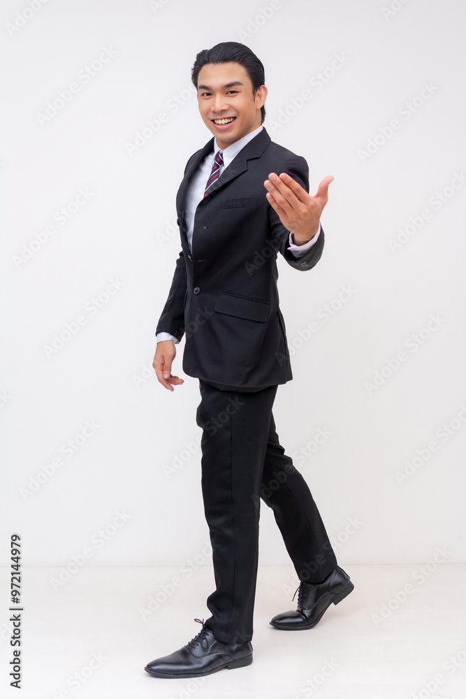 Full-body Portrait of a handsome asian businessman in a suit and tie, inviting you to come with him. Isolated on a white background. Full-body Portrait of a handsome asian businessman in a suit and tie, inviting you to come with him. Isolated on a white background.