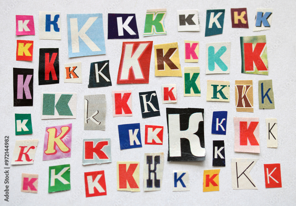 The letter K. bundle of paper letters cut out of magazines and newspapers in different sizes and fonts. white background.