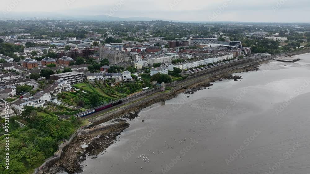 Steam Train, Blackrock, County Dublin, Ireland, September 2024. Drone follows the Dublin Riviera Express pulled by No.131 Steam Locomotive passing Idrone Terrace headed north towards the city center. Steam Train, Blackrock, County Dublin, Ireland, September 2024. Drone follows the Dublin Riviera Express pulled by No.131 Steam Locomotive passing Idrone Terrace headed north towards the city center.