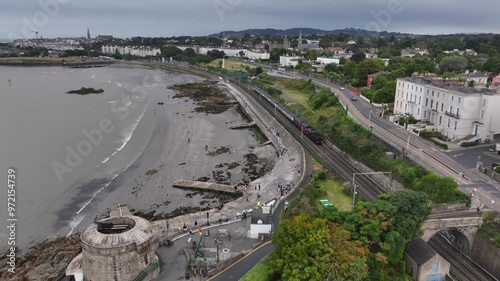 Steam Train, Seapoint, County Dublin, Ireland, September 2024. Drone follows the Dublin Riviera Express pulled by No.131 Steam Locomotive passing the Martello Tower steaming north towards Blackrock. photo