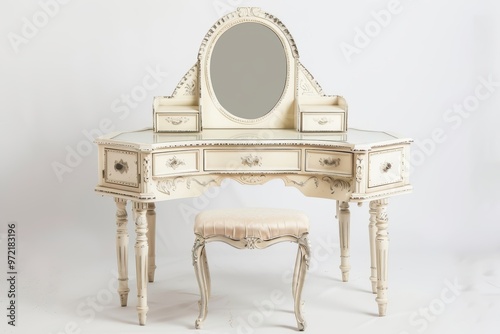 An elegant vintage vanity table with a classic mirror and matching stool in an off-white color