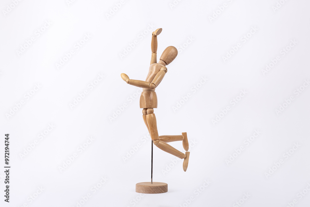 Wooden human figure jumping in sign of joy isolated on white background. Copy Space. Concept of joy and happiness Wooden human figure jumping in sign of joy isolated on white background. Copy Space. Concept of joy and happiness