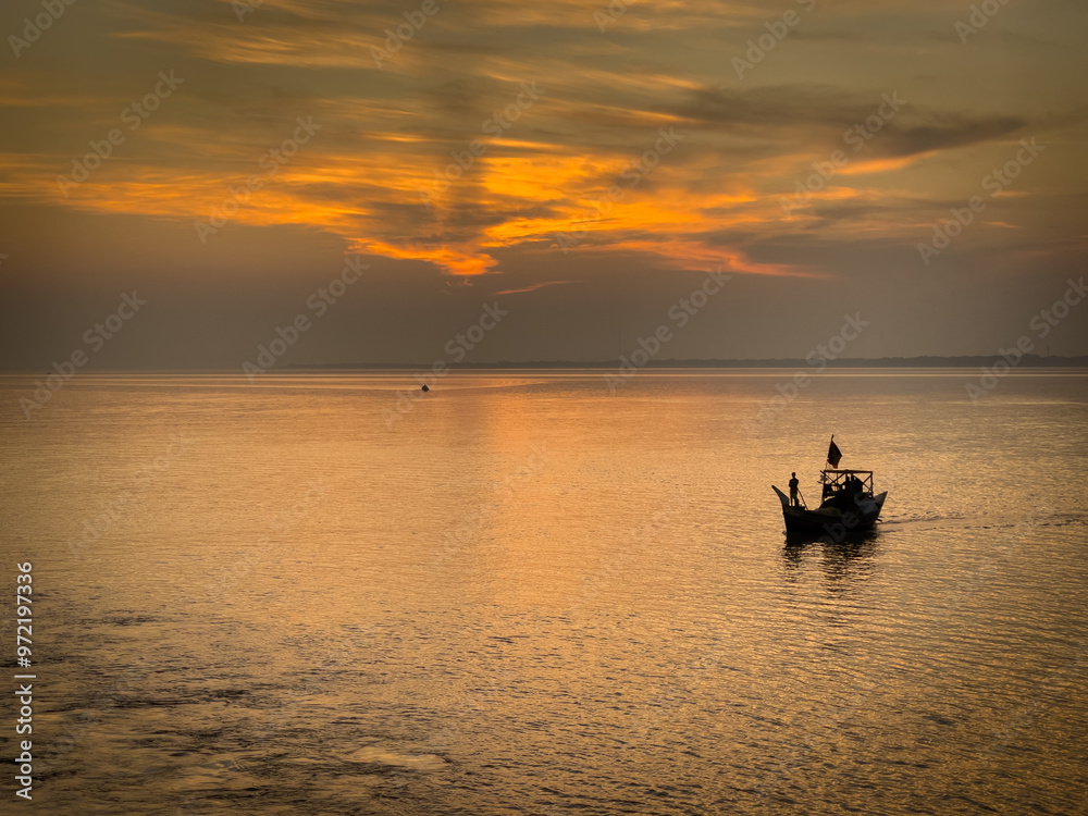 Fishing Boats on the River at Sunset. Landscape of Bangladesh and Fisheries Industry Concept Fishing Boats on the River at Sunset. Landscape of Bangladesh and Fisheries Industry Concept