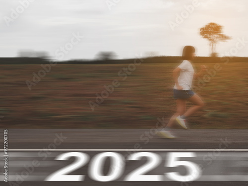 Female runner running at speed with the text 2025 on the asphalt road.